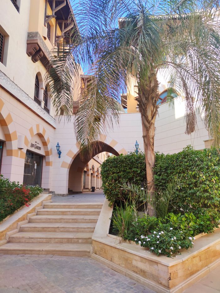 Beautiful courtyard in a luxury resort with architecture and palm tree in Hurghada, Egypt.